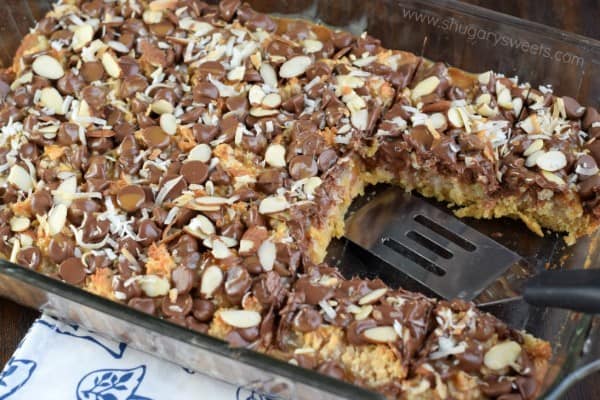 These Coconut Almond Bars are a delightful homemade candy bar recipe filled with toasted coconut and topped with chocolate, caramel, and crunchy almonds!