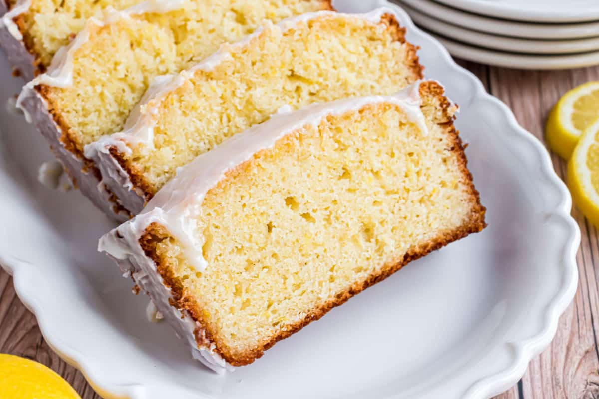 Lemon pound cake sliced on a white platter.