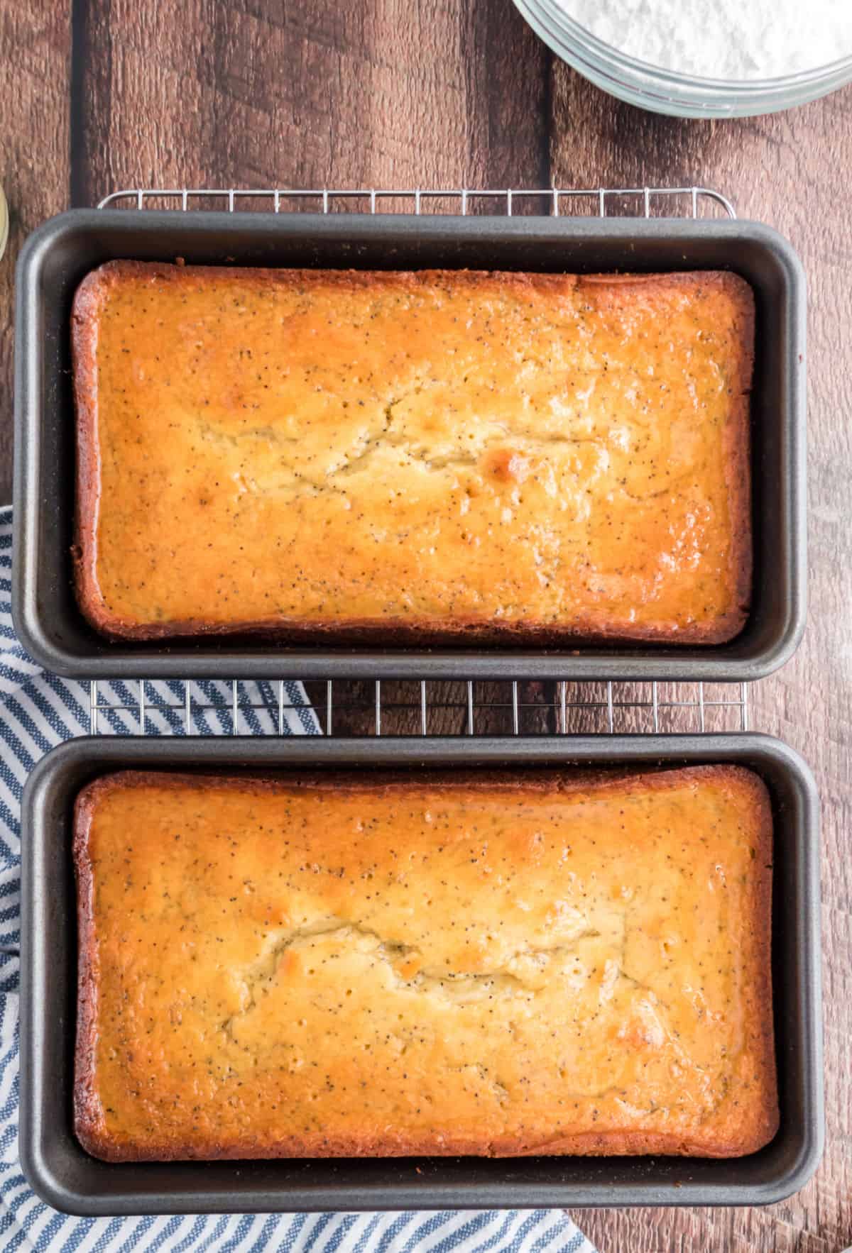 Two loaves of lemon bread with simple syrup.