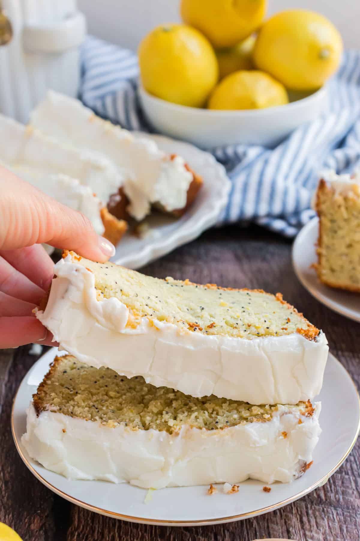 Two slices of lemon poppy seed bread on a white plate.