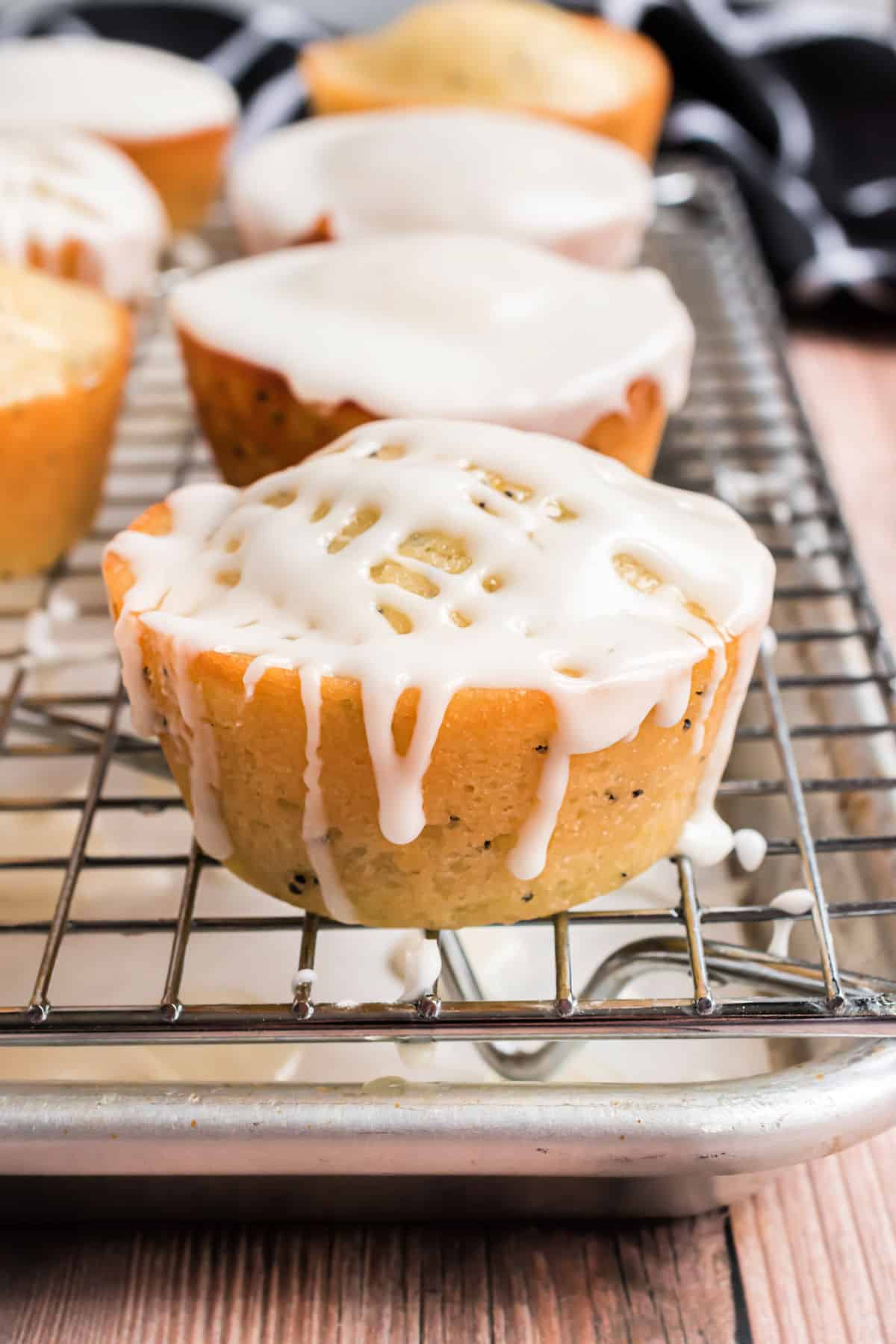 Lemon poppy seed muffins on a wire rack.