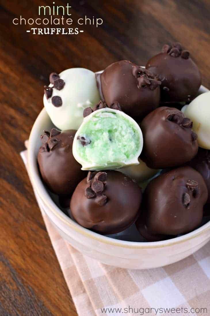 Serving bowl with mint chocolate chips truffles, one with a bite taken out.