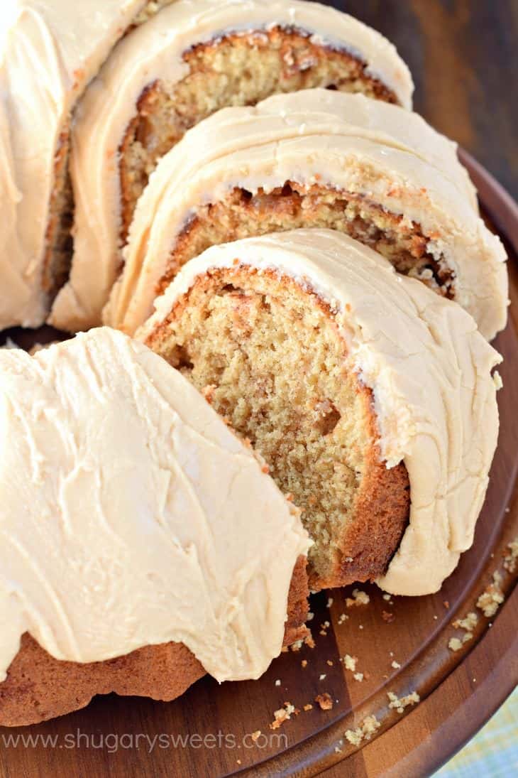Apple bundt cake cut into slices and topped with a caramel icing.