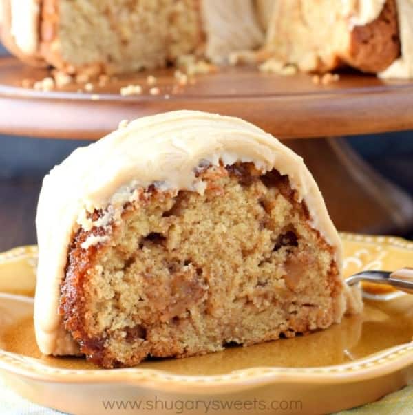 Slice of apple bundt cake on a gold plate.