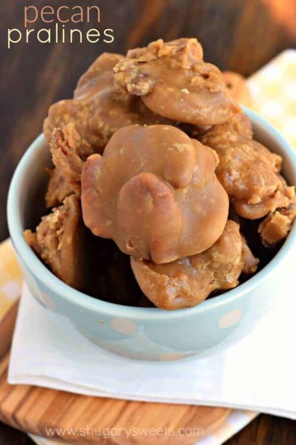 This buttery, brown sugar Southern candy is such a treat. Pecan Pralines are a classic that you have to try! Blue and white bowl with pecan pralines brimming to the top