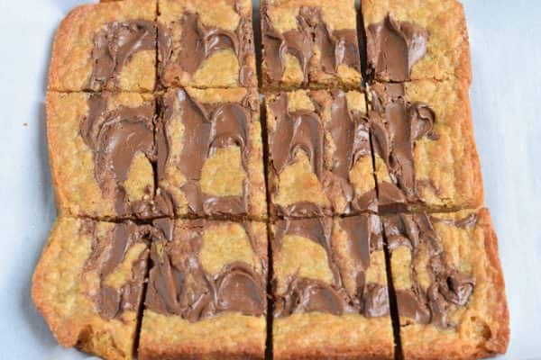 Easy, chewy, Nutella Swirled Blondies. Topped with ice cream, melted Nutella and sprinkles! Perfect way to celebrate that special occasion!