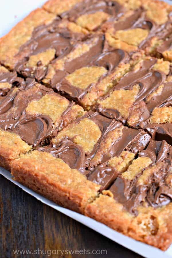 Easy, chewy, Nutella Swirled Blondies. Topped with ice cream, melted Nutella and sprinkles! Perfect way to celebrate that special occasion!