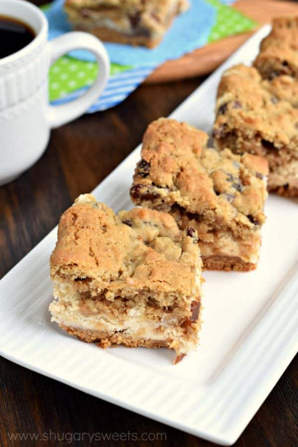 Soft and chewy oatmeal raisin cookie on top of a creamy cheesecake bar! These Oatmeal Raisin Cookie Cheesecake Bars are delicious, comfort food treats!