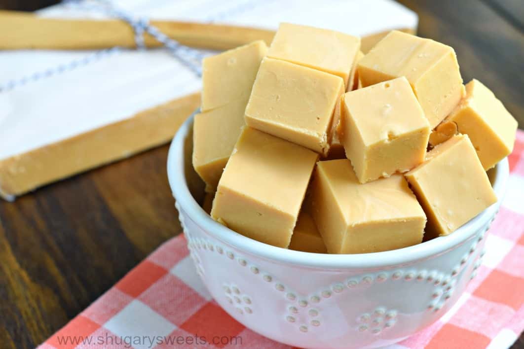 Butterscotch fudge in white bowl on linen napkin.