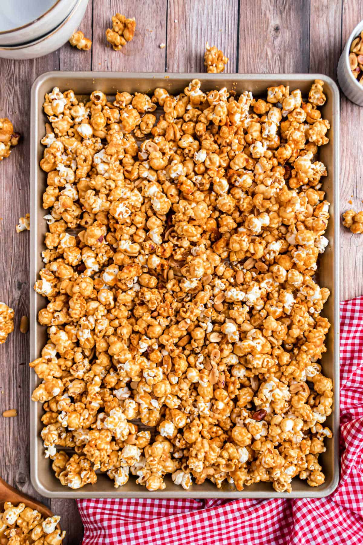 Baking sheet with baked caramel corn and peanuts.