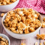 Homemade caramel corn in a white bowl.