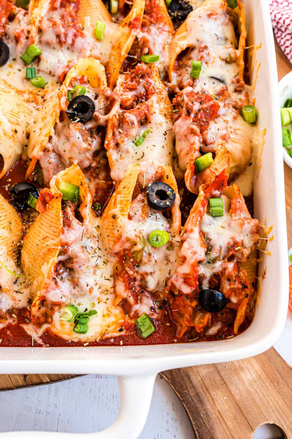 Baked pasta shells in a white baking dish.