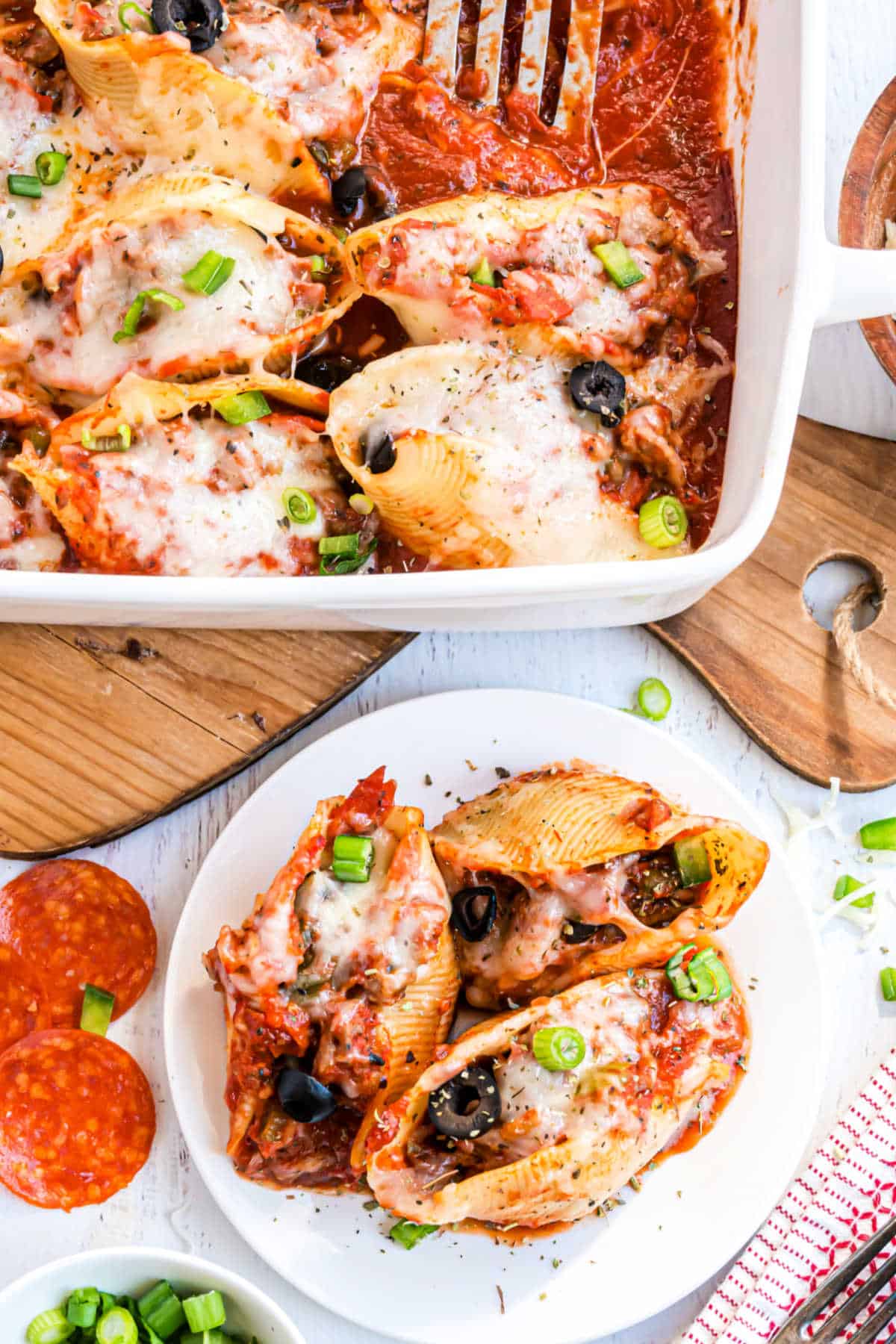 Pasta shells stuffed with pizza sauce and toppings.