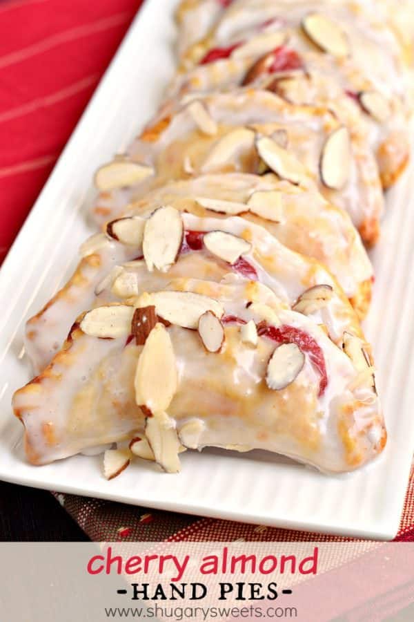 Easy, baked Cherry Almond Hand Pies! A flaky crust with a cherry almond pie filling, dipped in a sugary glaze and topped with sliced almonds. The perfect dessert!