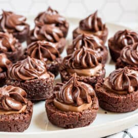 These Chocolate Caramel Brownie Bites are fudgy bite-sized treats perfect for a crowd! Chewy chocolate brownies get an extra boost of decadence from a caramel candy center and rich caramel swirled frosting.