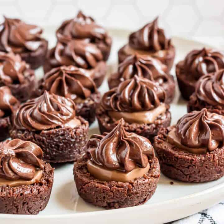 These Chocolate Caramel Brownie Bites are fudgy bite-sized treats perfect for a crowd! Chewy chocolate brownies get an extra boost of decadence from a caramel candy center and rich caramel swirled frosting.
