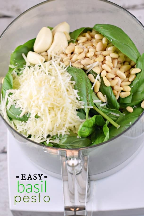 Pesto ingredients in a food processor before blending.