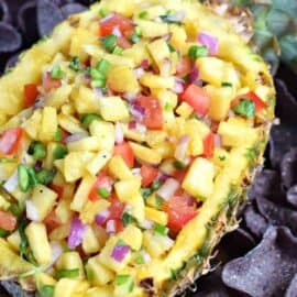 Tropical Pineapple Salsa is a spicy, sweet, colorful snack idea! So versatile, you can enjoy with tortilla chips or spoon it over your favorite grilled chicken or fish!