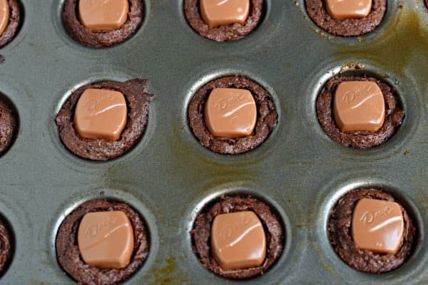 Decadent, fudgy Chocolate Caramel Brownie Bites with DOVE Chocolate. Chewy chocolate brownies with a creamy caramel candy filling! Topped with a rich chocolate caramel frosting, these brownie bites are the perfect birthday treat!