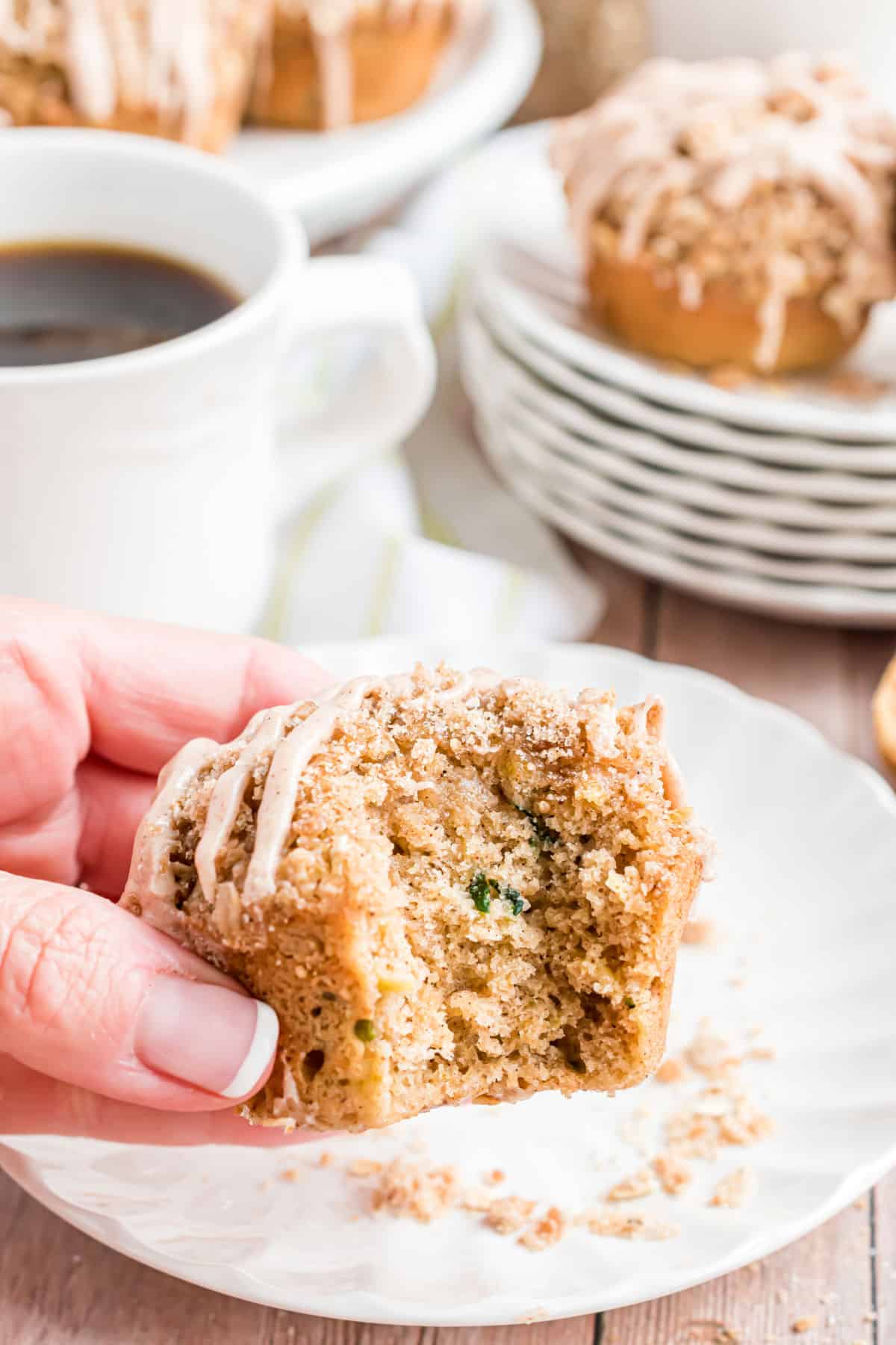 Zucchini muffins with a bite taken out.