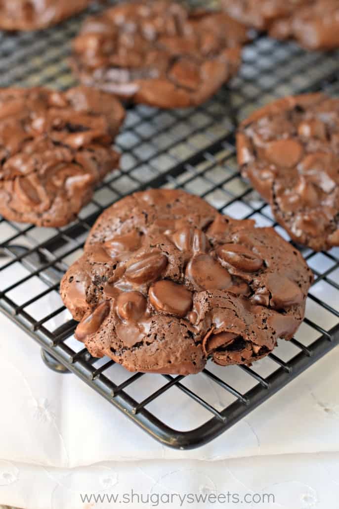 Black wire rack with chocolate meringue cookies.