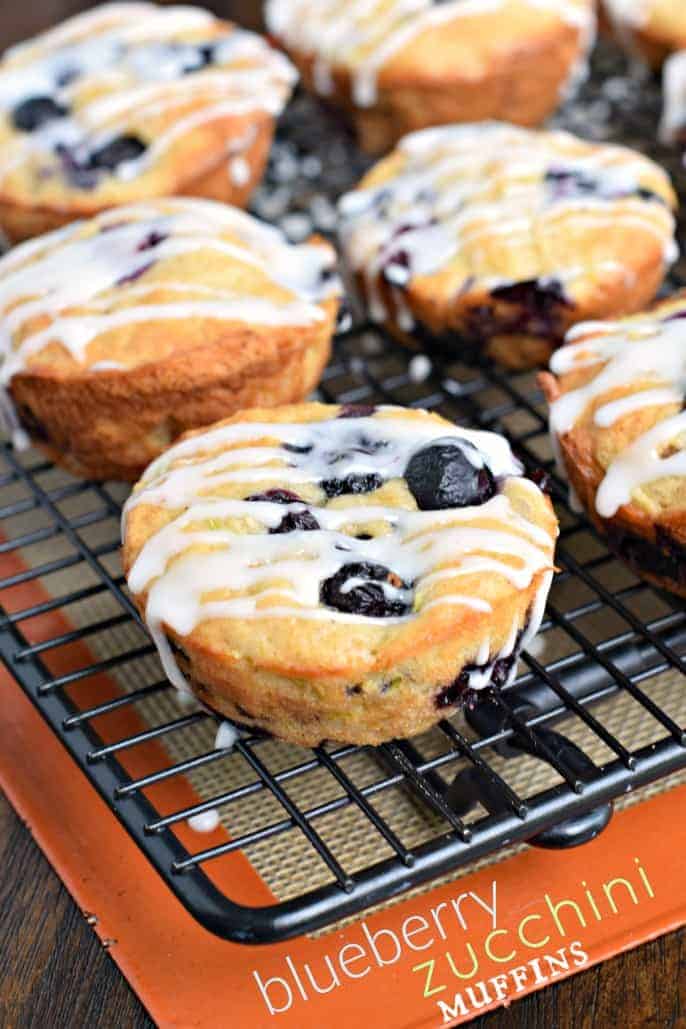 Blueberry muffins on black wire rack.