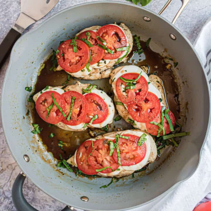Caprese Chicken Skillet - Delicious pan seared chicken topped with mozzarella, tomatoes, basil and balsamic. This dinner has a gourmet flair and is ready in just 15 minutes!