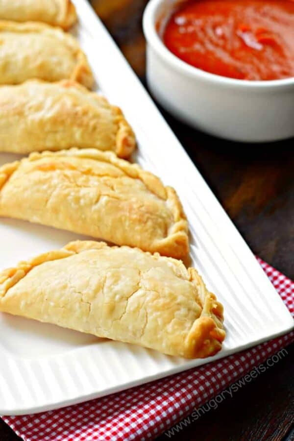 Flaky pie crust filled with pepperoni and cheese. These baked Pepperoni Pizza Hand Pies are ready in minutes and make a great meal!