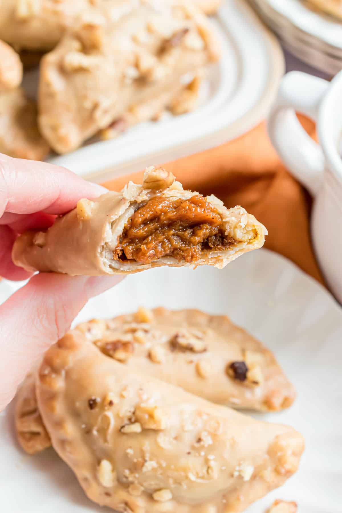 Pumpkin hand pie with a bite taken out.