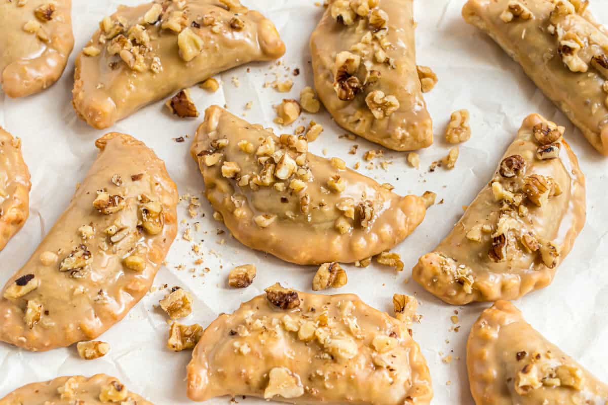 Pumpkin hand pies on parchment paper lined cookie sheet.