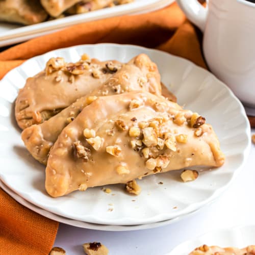 These Pumpkin Hand Pies are the perfect fall treat! The flaky crust and nutty pumpkin pie filling are the perfect combo in a hand pie, plus they’ve got a wonderful maple walnut glaze!