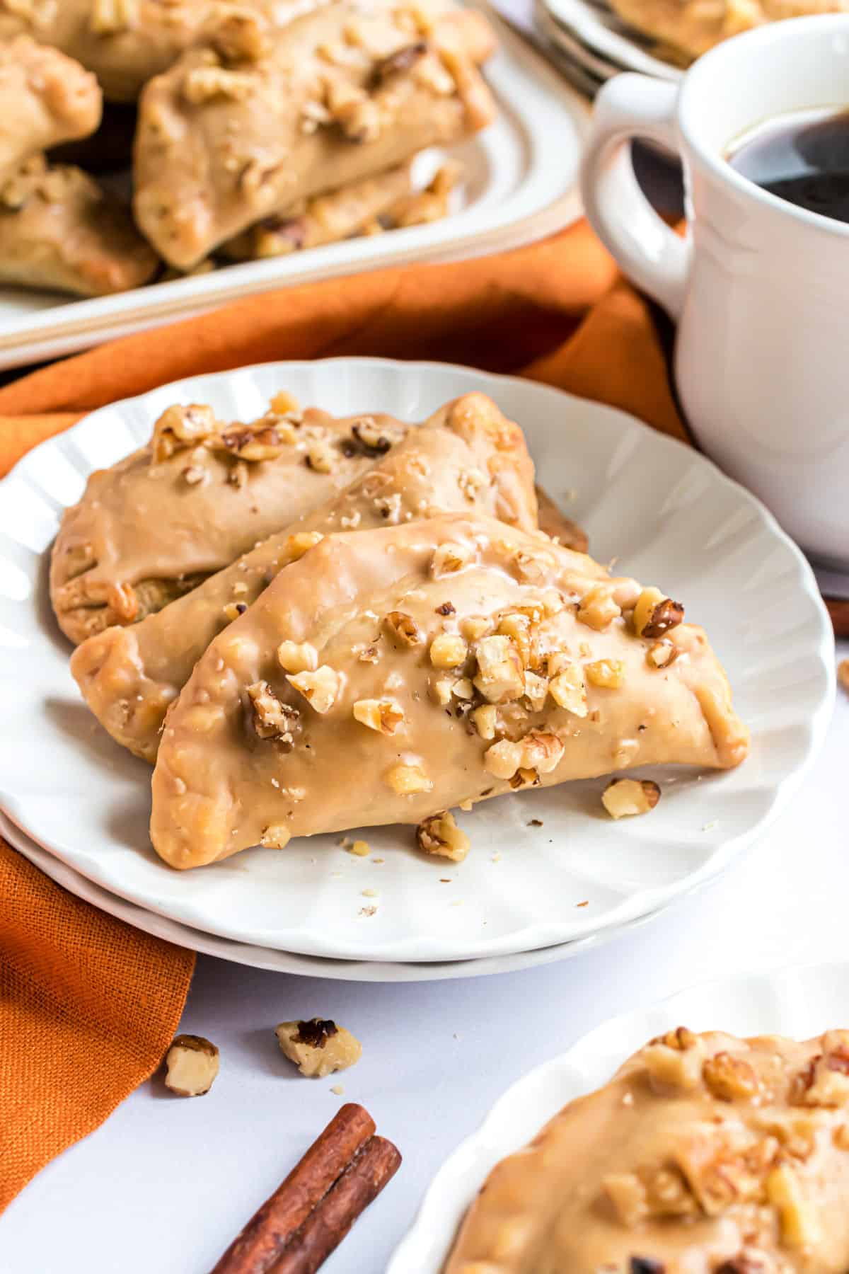 Pumpkin hand pies topped with a glaze and nuts.
