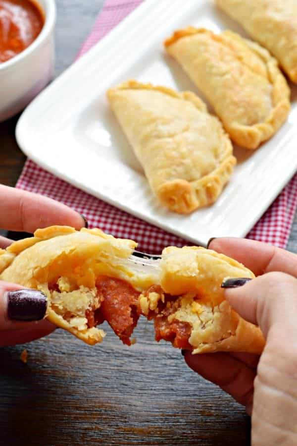 Flaky pie crust filled with pepperoni and cheese. These baked Pepperoni Pizza Hand Pies are ready in minutes and make a great meal!