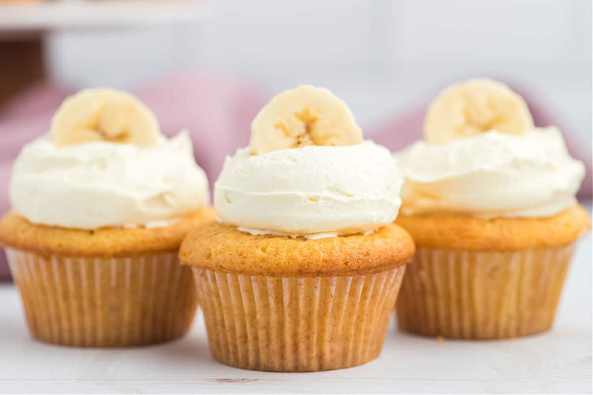 Banana pudding cupcakes with fresh banana and whipped cream.