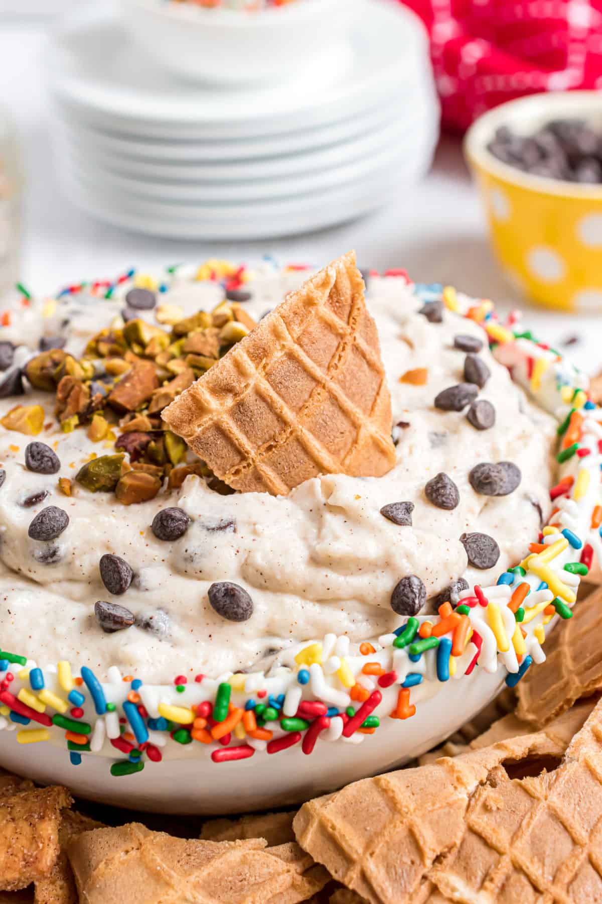 Cannoli dip served in a bowl with a rim of sprinkles.