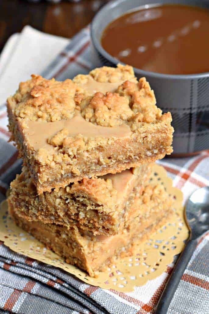 Stack of three peanut butter oatmeal bars on a tan doily.