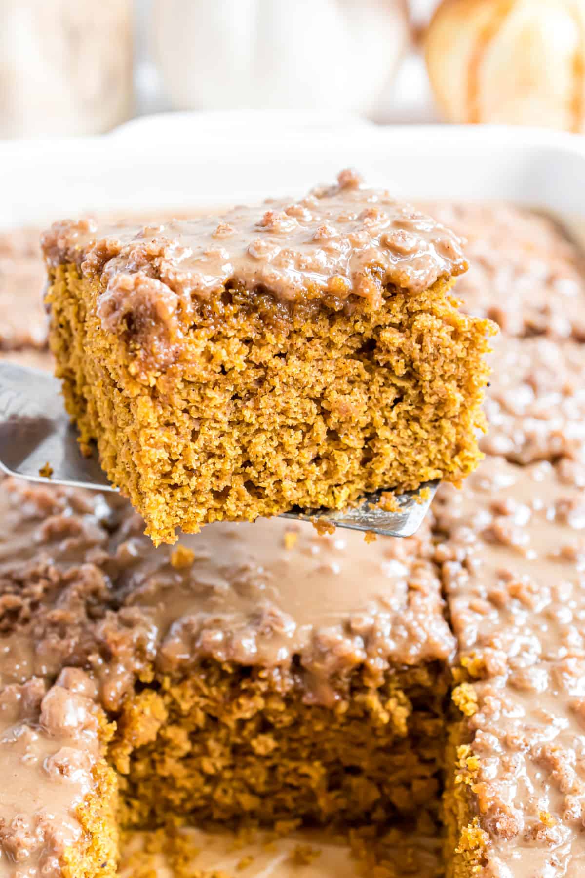 Slice of pumpkin coffee cake being lifted out of baking dish.