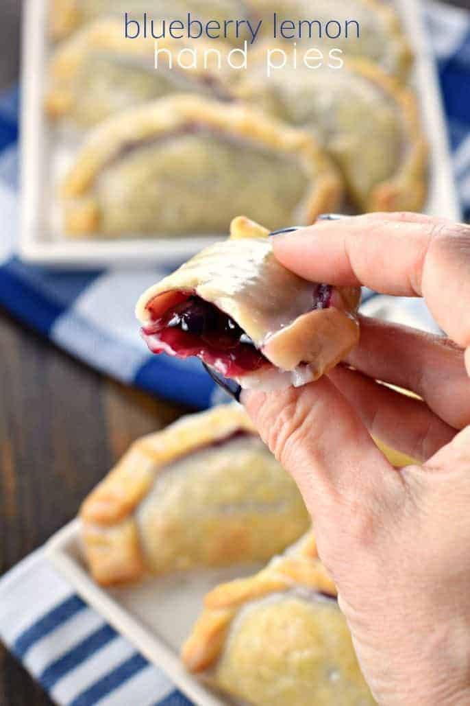 Blueberry hand pie bit into so you can see center. Topped with lemon glaze.