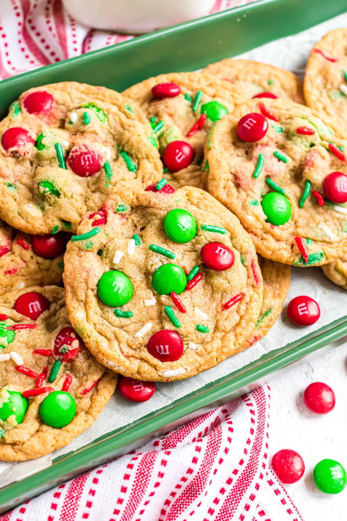 Christmas m&m cookies on a green serving plate.