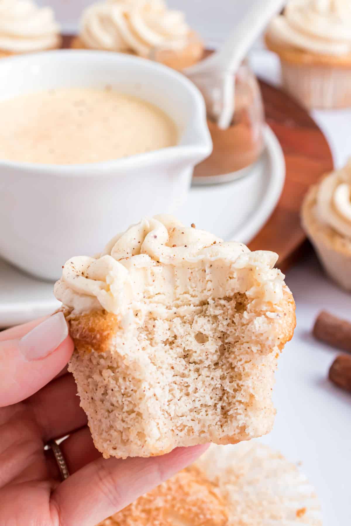 Eggnog cupcake with a bite taken out.