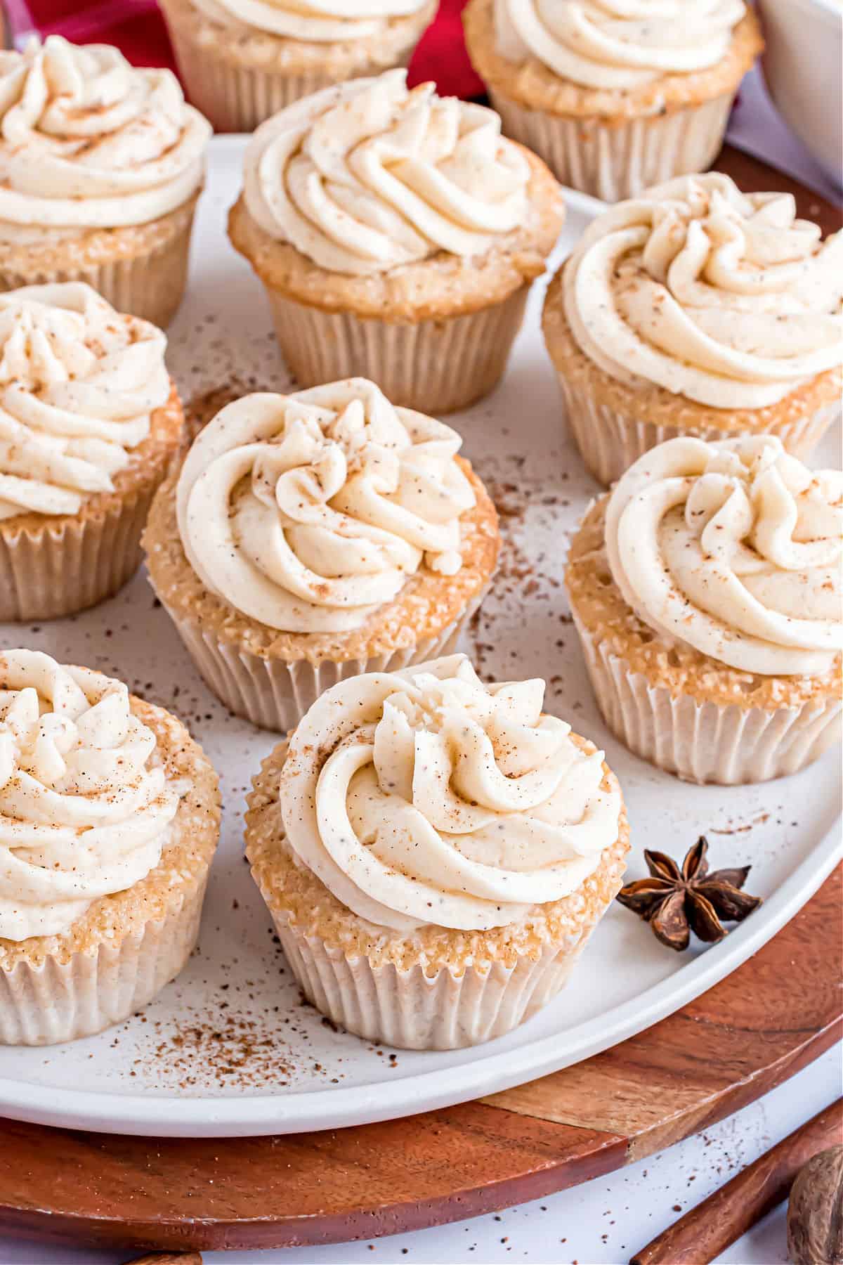Eggnog frosted cupcakes on a white serving platter.