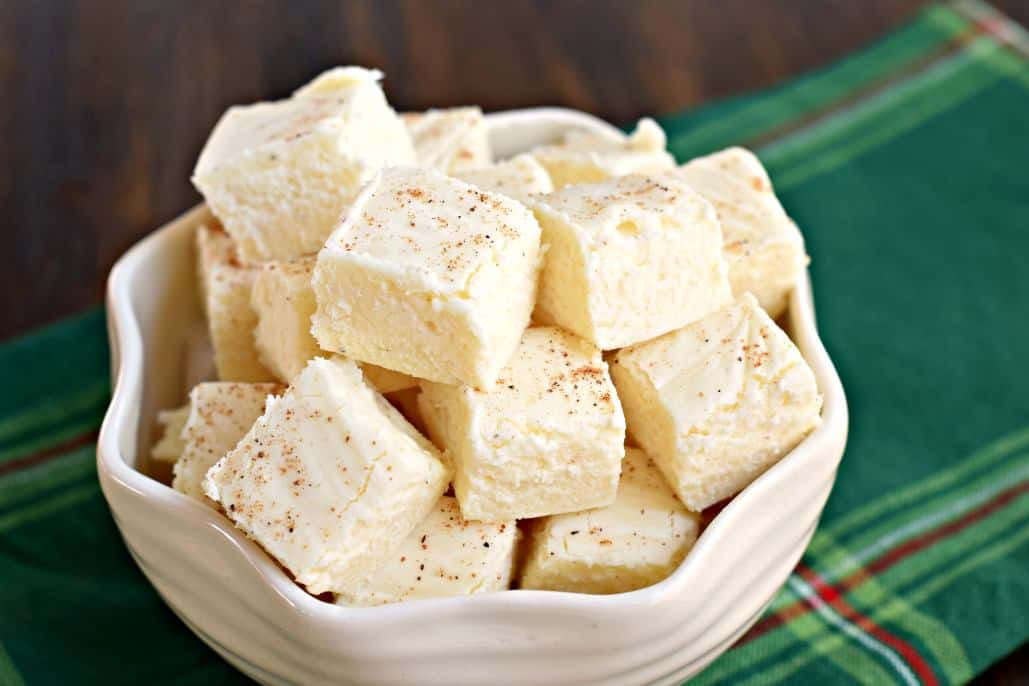 Bowl of eggnog fudge on a green linen napkin.