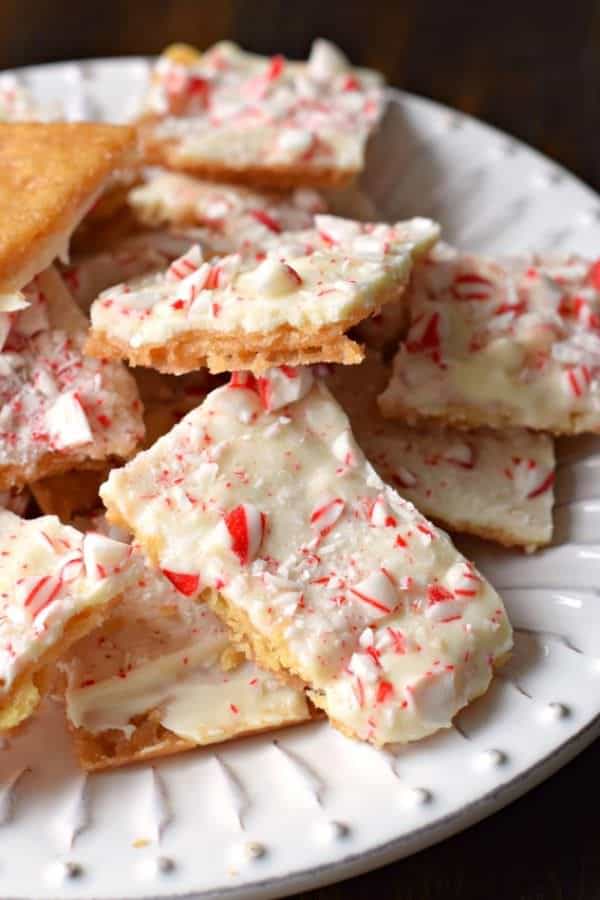This Peppermint Cracker Toffee is ridiculously easy and delicious. Crisp, buttery toffee topped with white chocolate and peppermint candy!