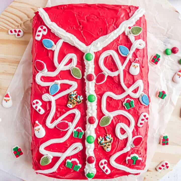 Cake with red frosting decorated like an ugly holiday sweater.