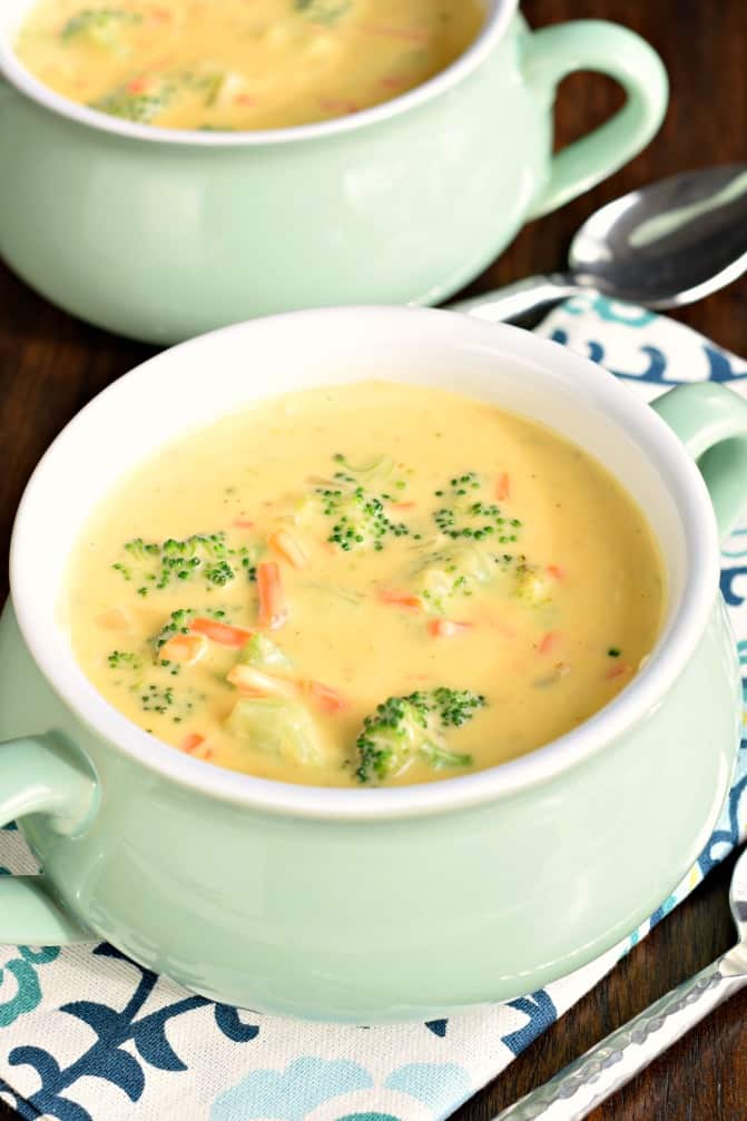 Broccoli Cheese Soup served in green soup bowls.