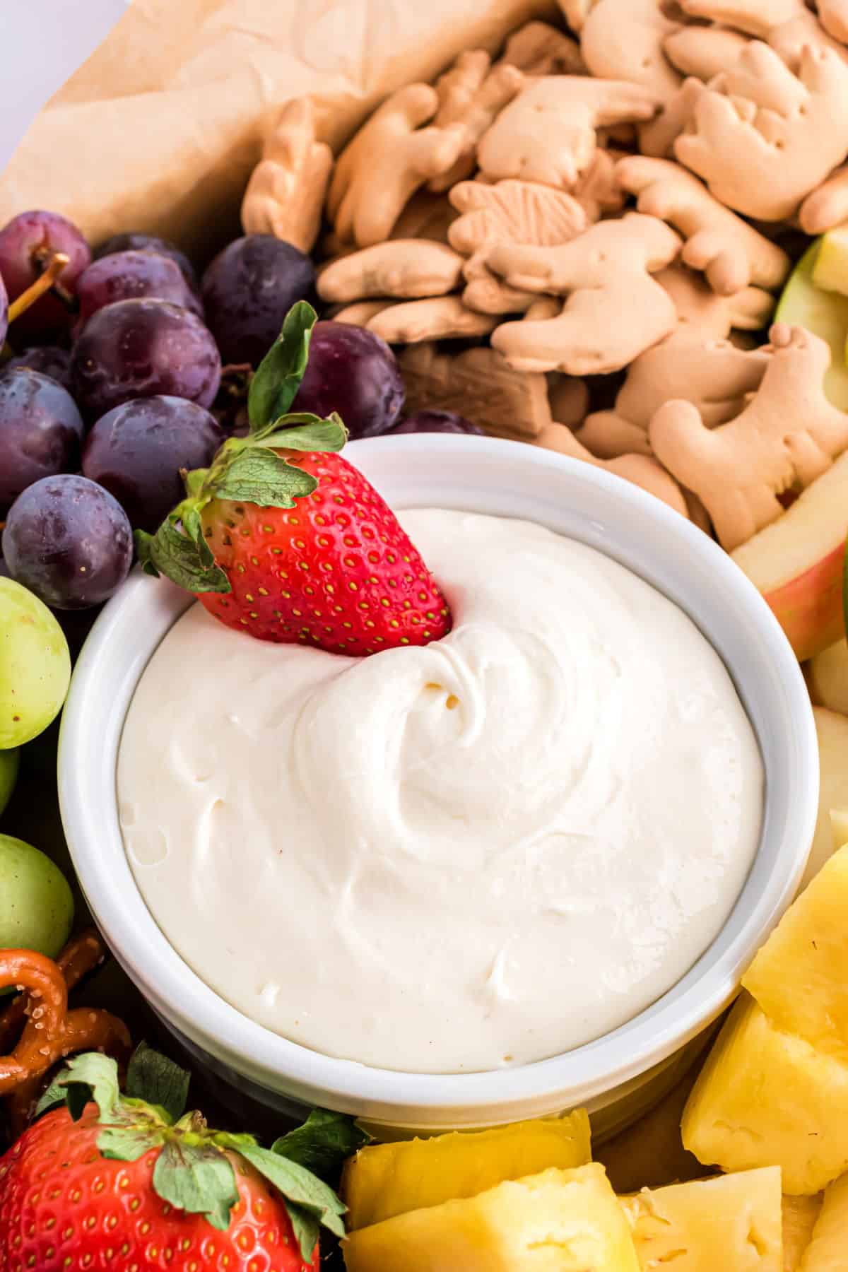 Cream cheese dip with a strawberry to scoop.