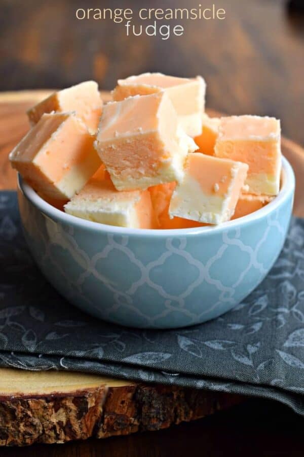 Orange Creamsicle Fudge is like your favorite ice cream treat from the truck - but it doesn't melt! Just the right amount of sweet for an afternoon jolt of happiness. #orangefudge #fudge #christmascandy #creamsicle #dreamsicle #orange #homemadecandy #candy #fudgeshop