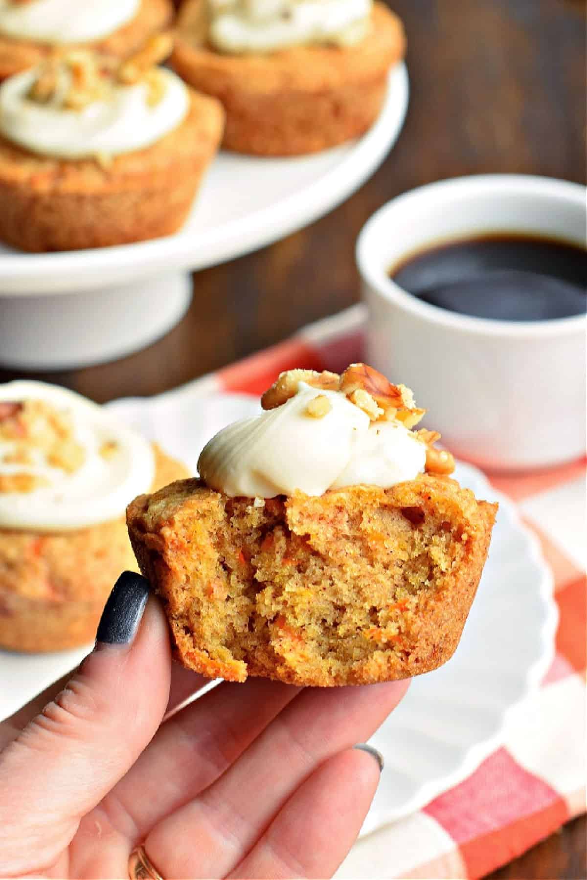 Carrot cake muffin with a bite taken out.