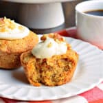 Carrot Cake Muffins--a moist and sweet breakfast treat! Topped with cream cheese frosting and walnuts, these easy to make muffins are the best way to start your day.