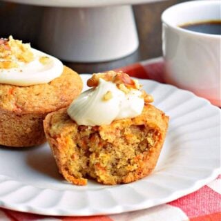 Carrot Cake Muffins--a moist and sweet breakfast treat! Topped with cream cheese frosting and walnuts, these easy to make muffins are the best way to start your day.